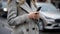 Woman in a gray coat using a smartphone on the street.