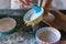 Woman greasing baking mould before adding batter