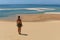 Woman with green bikini at beach overlooking turquoise water