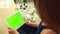 Woman with green chromakey tablet