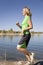 Woman in green runs at lake