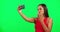 Woman, green screen and selfie with kiss, smile and mockup space with post on social network. Influencer girl, model or