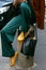 Woman with green silk trousers and yellow Vans shoes before Antonio Marras fashion show, Milan Fashion Week