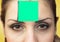 Woman with green sticky note on her forehead