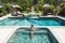 Woman in green swimsuit relaxing in outdoor jacuzzi with clean transparent water