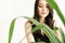 Woman with greenery on white background with copy space. Summer fashion photo. Skin care concept, bio product