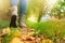 Woman in grey shoes and jeans walking on the autumn forest path