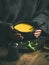 Woman in grey woolen winter sweater eating sweet corn soup