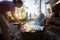 Woman Grilling Food On Skewers With Friends In Background