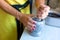 A woman grinds nuts in a mortar. Seasoning making