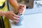 A woman grinds nuts in a mortar. Seasoning making