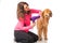 Woman grooming dog with a blowdryer