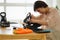 A woman grooming a snowboard board