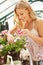 Woman Growing Plants In Greenhouse