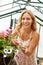 Woman Growing Plants In Greenhouse