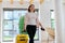 Woman guest tourist with suitcase in hotel lobby interior.