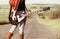 Woman with guitar at freeway