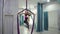 Woman in gym hangs on aerial silk wrapped around her chest.