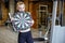 Woman in the gym holding a dartboard target. The concept of success and achievement of goals, results