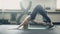 A woman in the gym makes stretching exercises for her back muscles.