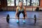 Woman In Gym Preparing To Lift Weights