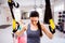 Woman in gym training arms with trx fitness strips