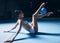 Woman, gymnastics and legs with ball for dancer performance, competition training or dark sports arena. Female athlete