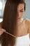 Woman With Haircomb In Hand Hairbrushing. Hair Health