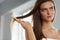 Woman With Haircomb In Hand Hairbrushing. Hair Health