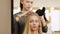 The woman the hairdresser does a hair for a professional photoshoot of the girl of model.