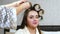 Woman Hairdresser put on Curlers to Long Hair Woman