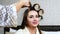 Woman Hairdresser put on Curlers to Long Hair Woman