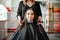 Woman in hairdressing salon, female stylist