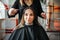 Woman in hairdressing salon, female stylist