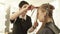 Woman hairstylist using razor for cutting long hair in beauty studio. Close up female hairstyle in hairdressing salon.