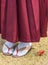 Woman in hakama kimono with geta shoes on the grass in autumn.