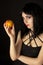 Woman with halloweeen make up holding peach