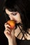 Woman with halloweeen make up smelling peach