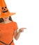 Woman in Halloween hat pointing on copy space