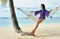 Woman in hammock on beach