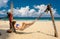 Woman in hammock on beach