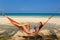 Woman in hammock on beach