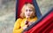 Woman in a hammock with a cup of coffee in outdoors