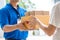 Woman hand accepting a delivery of boxes from deliveryman