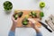 Woman hand adding broccoli to measuring cup