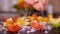 Woman hand adding salt to vegetables mix - closeup, slow motion