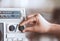 Woman hand adjusting the sound volume on retro radio cassette