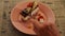 Woman hand breaks off piece of chocolate cake with teaspoon. Young lady eating