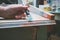 Woman hand with brush paint wooden desk with chalky paint