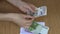 Woman hand count bribe money cash euro banknotes in envelope. 4K